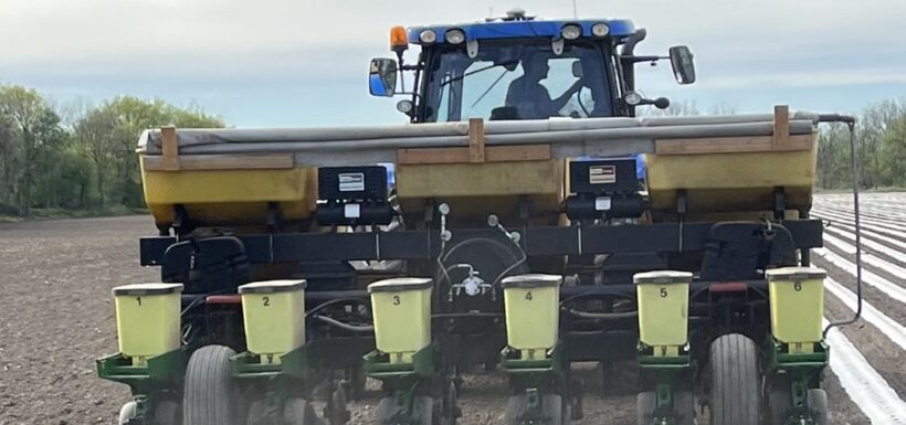 Tractor planting seeds in a field.